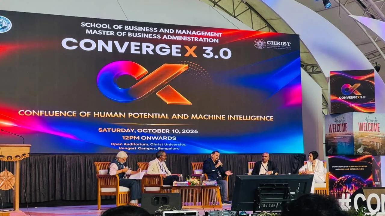 Panel discussion on the human-AI partnership at ConvergeX 3.0, CHRIST University Bengaluru, with five panellists on stage under the event banner